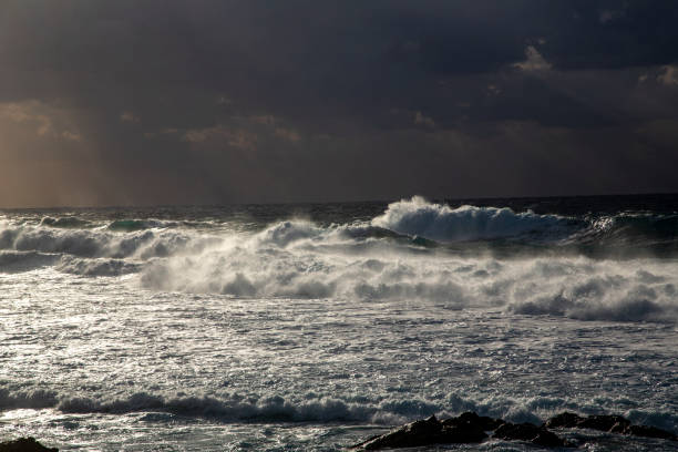 Waves crashing over coastline at Storsandnes, Lofoten Islands, Norway in Napp, Nordland, Norway