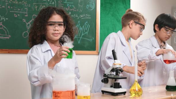 istock Attractive children doing experiment in science lesson at laboratory. Pedagogy. 2193060381