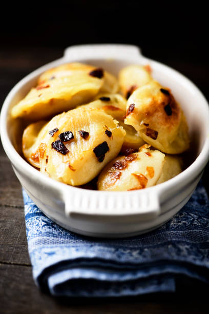 istock Dumplings with potato and cottage cheese stuffing (pierogi). Wooden background. Copy space. 2193063261