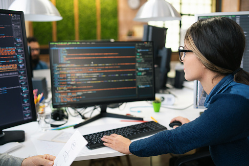 freelance coder programming server code algorithm on... Female Freelance Developer Coding And Programming Coding On Two With ...
