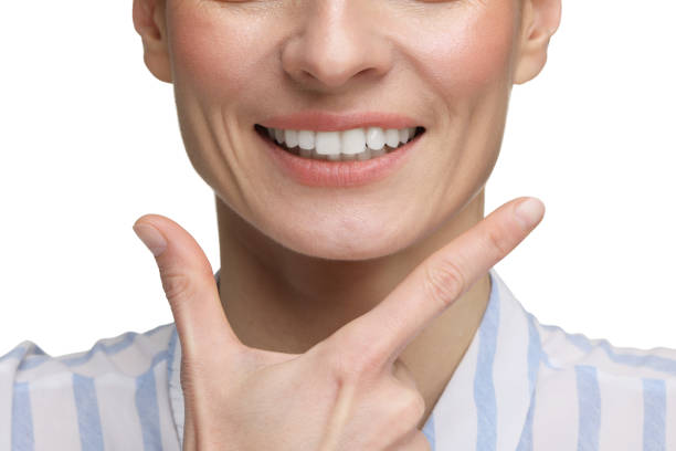 istock Woman showing her clean teeth and smiling on white background, closeup 2193065037