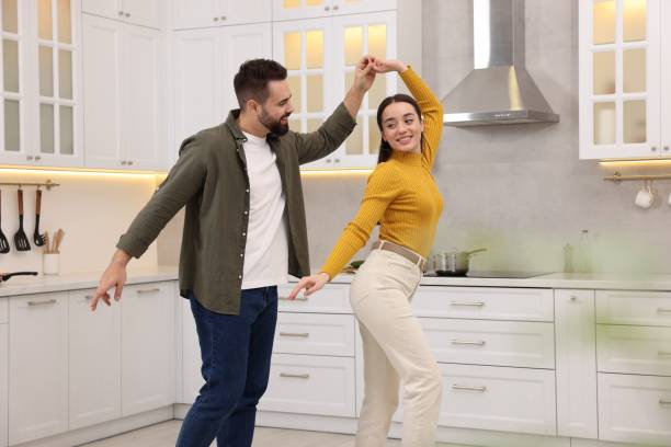 istock Happy lovely couple dancing together in kitchen 2193065362
