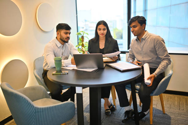 istock Young professionals collaborating in a modern meeting room 2193065380