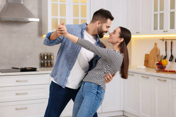 istock Happy lovely couple dancing together in kitchen 2193065436