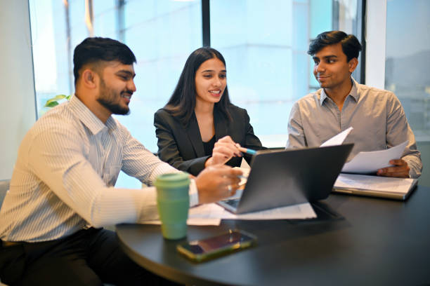 istock Young professionals collaborating in a modern meeting room 2193065462