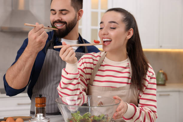 istock Happy lovely couple cooking together in kitchen 2193065576