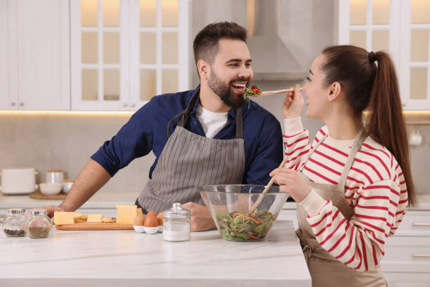 istock Happy lovely couple cooking together in kitchen 2193065599