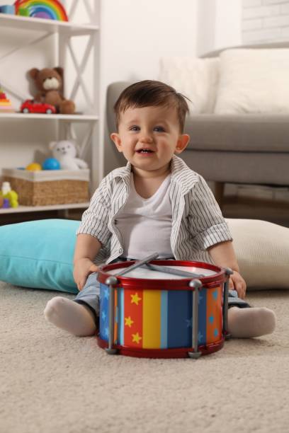 istock Cute little boy with toy drum at home 2193066752