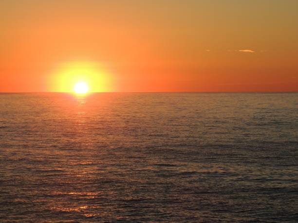 istock Sunset over the ocean with vibrant orange hues. 2193072567