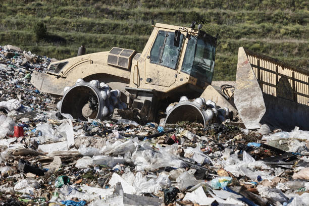 istock Heavy machinery shredding garbage in an open air landfill. Pollution 2193072943