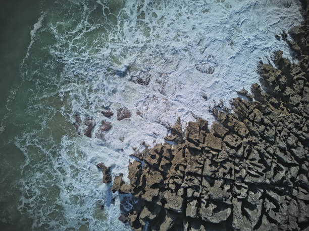Breaking waves on a rocky shore aerial scenic view, Cascais, Portugal