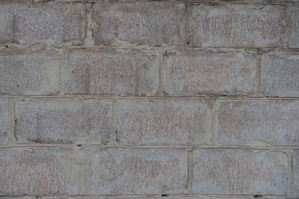 istock Closeup of whitewashed wall made of concrete masonry units 2193073743