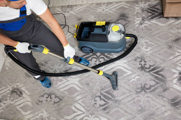 istock Specialized cleaning company worker with vacuum cleaner cleaning a carpet 2193074030