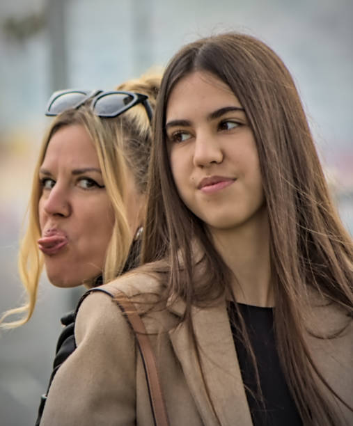 Elegant and stylish mother and daughter funny portrait close up view, Lisbon, Portugal