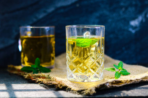 istock Two glasses of mint tea with mint leaves on a black marble background 2193076305