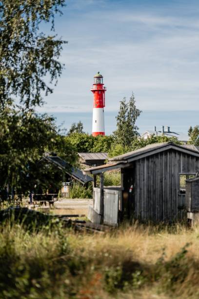 istock Vibrant red and white Tankar Lighthouse stands tall against a blue sky 2193078335