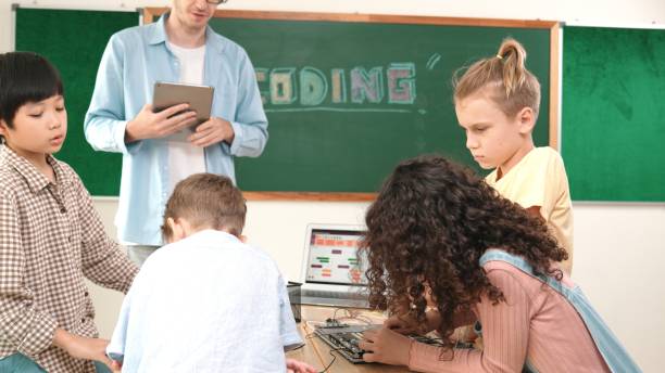 istock Group of diverse student working together while teacher hold tablet. Pedagogy. 2193079233