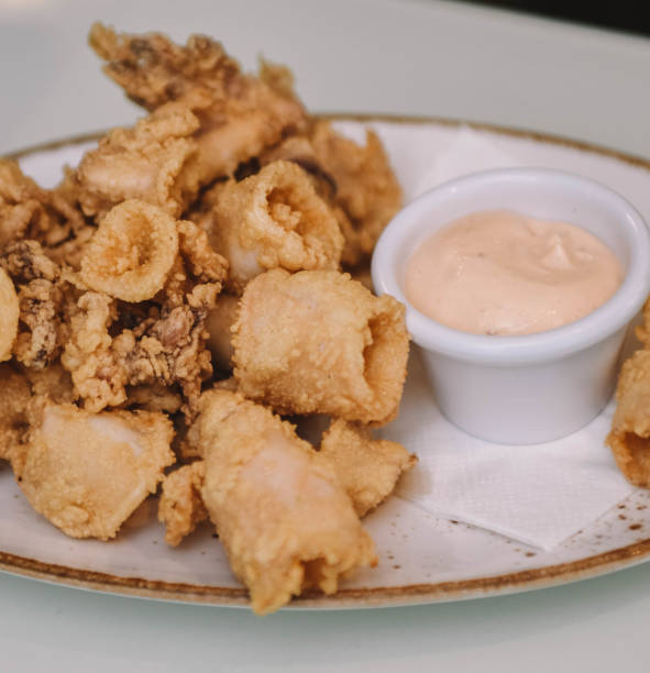 istock Fried squid with mayonnaise sauce on white plate. 2193084526