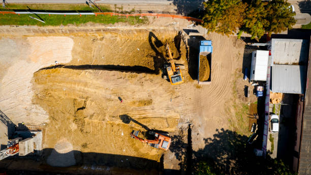 istock Ariel view excavator is loading a truck with ground on building site 2193085966
