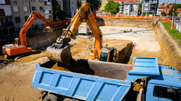 istock Ariel view excavator is loading a truck with ground on building site 2193085968