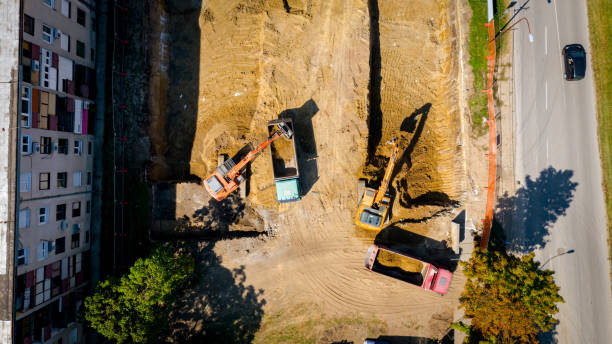 istock Ariel view excavator is loading a truck with ground on building site 2193086091