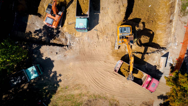 istock Ariel view excavator is loading a truck with ground on building site 2193086093