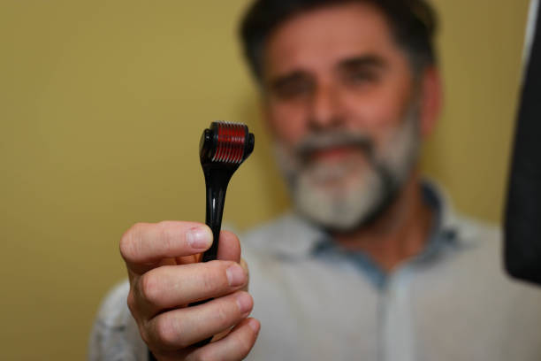 istock Senior man using derma roller for skin care 2193086205