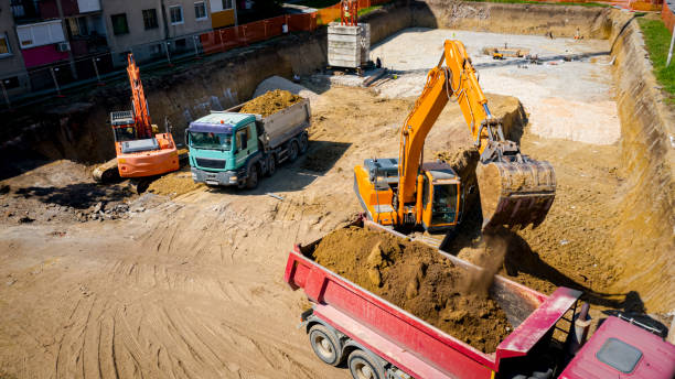 istock Ariel view excavator is loading a truck with ground on building site 2193086243