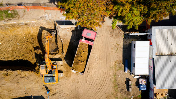 istock Ariel view excavator is loading a truck with ground on building site 2193086322
