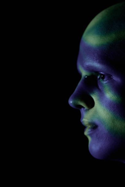istock Profile of Sad Bald Man Standing in Blue Projector Light against Black Background 2193086403