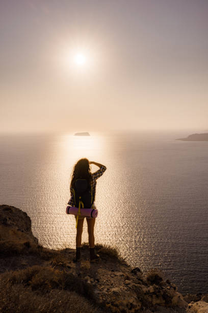 istock Back view of a backpacker looking at sea view from a hill. 2193086731