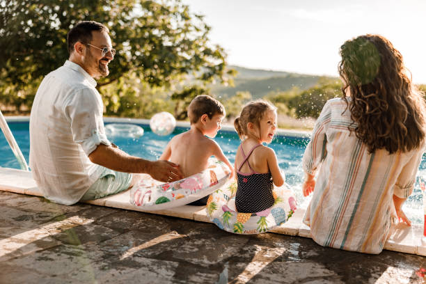 istock Happy family talking by the pool in summer day. 2193088094