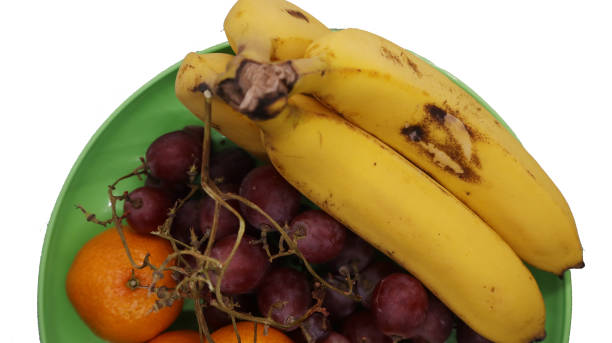 close-up photo of banana grapes and orange fruit on white background. Isolated