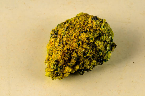 istock A yellow rock with green specks on it 2193094290