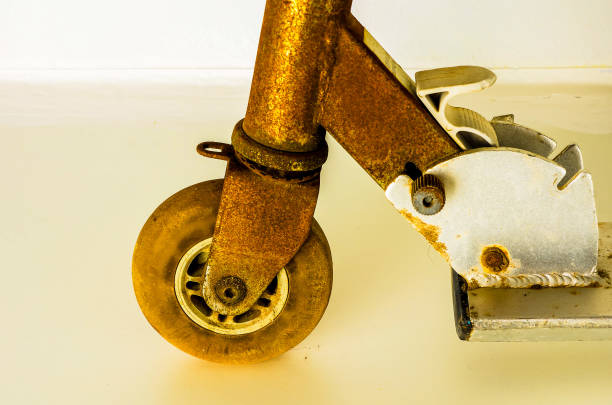 A rusty scooter wheel is shown in the image. The wheel is old and worn, with a rusted appearance. The scooter itself is not in use, and it is abandoned or forgotten