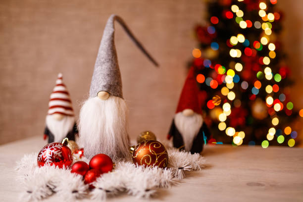 istock Festive Christmas Gnome Decorations with Ornaments and Bokeh Christmas Tree in Background 2193096859