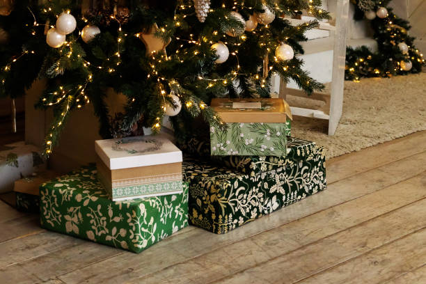 istock Beautiful gift boxes under a Christmas tree on wooden rude floor, copy space. 2193098034