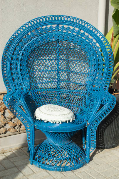 istock Blue curved wicker rattan chair with pillow closeup 2193099527