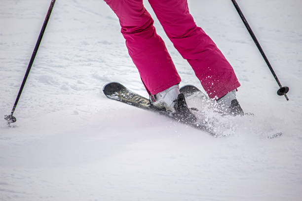 Male Braking While Skiing Downhill