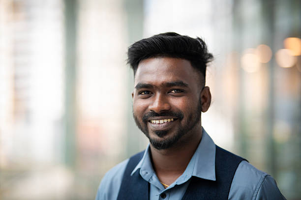 istock Young Indian male entrepreneur smiling and looking at camera in modern office 2193104837