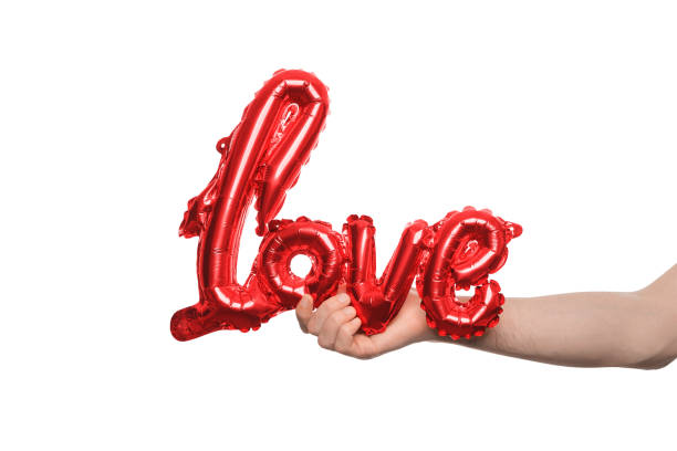 istock Hand holding a red love balloon, symbolizing affection and romance. 2193104873