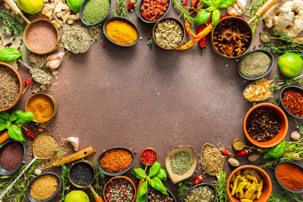 istock A diverse collection of vibrant spices and herbs, elegantly positioned on a brown backdrop, exuding natural beauty and a burst of fragrances, spice frame 2193107932