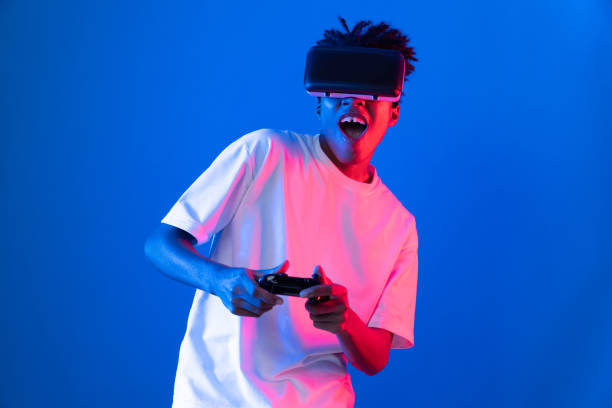 istock American African player wearing VR joystick neon lighting wall. Contrivance. 2193108898