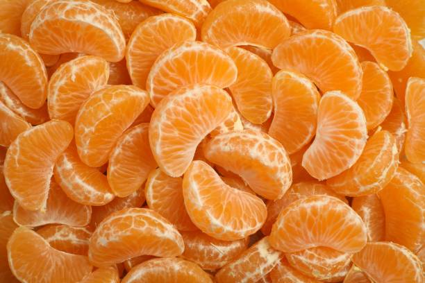 istock Delicious tangerine segments as background, top view 2193108970