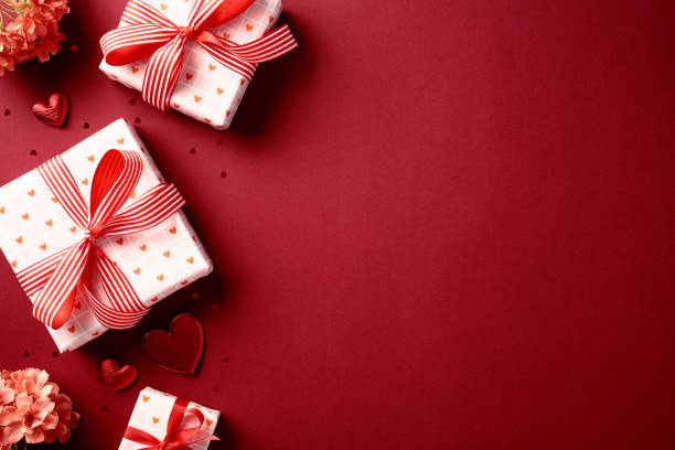 istock Beautiful gift boxes, flowers and heart decorations on red background, Top view with space for text. Valentine's day celebration concept. 2193111520