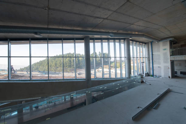 istock A captivating view of a modern business building under construction, showcasing its raw industrial interior with exposed steel beams and concrete walls bathed in the warm, golden hues of a sunset 2193112008