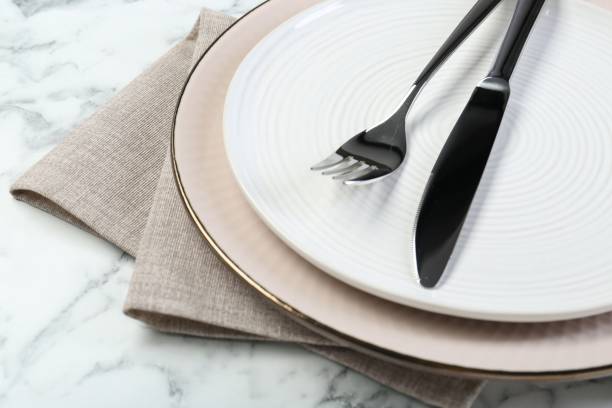 istock Clean plates, cutlery and napkin on table, closeup 2193112456