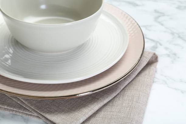 istock Clean plates, bowl and napkin on table, closeup 2193112516