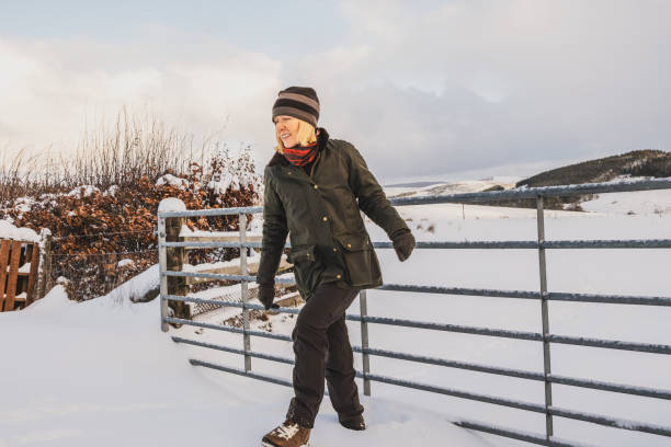 istock Female farmer looking over her field in winter 2193113676