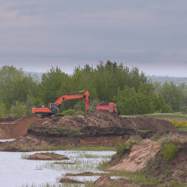 istock Excavator and truck in quarry 2193114648